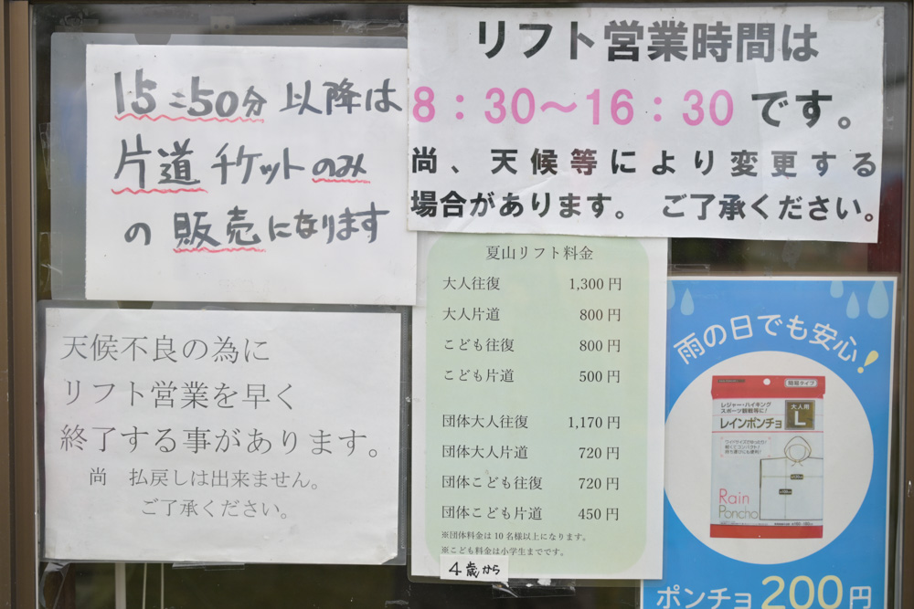 湯の丸高原スキー場の夏山リフト料金表と営業時間の案内。湯の丸山登山やレンゲツツジ観賞に便利なリフトの利用料金や運行時間が掲示されている。